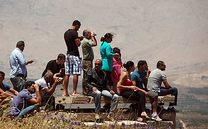 Druze watch fighting across border (Photo: EPA)