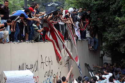 מתפרעים מחוץ לשגרירות ארה"ב בקהיר, אמש (צילום: AP)