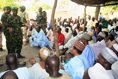 חיילים מדברים עם כפריים על ההצטרפות לבוקו חראם (צילום : AFP PHOTO / NIGERIAN MILITARY)